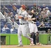  ?? ERIC ESPADA/GETTY IMAGES ?? Typical scene at Marlins Park: Half-bored fans watch another team’s star (Angels slugger Mike Trout) go deep.