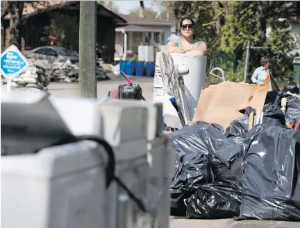  ?? ALLEN MCINNIS ?? Sonia Brown’s possession­s have been reduced to a pile of water-ravaged trash. Brown, who has lived on Île-Mercier with her husband for the last four years, says she will have to repair her damaged home’s pipes, electrical panel and hot water tank,...