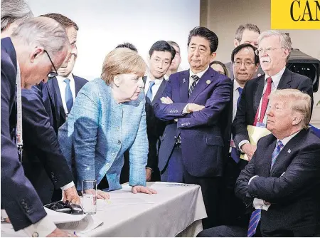  ?? JESCO DENZEL/BUNDESREGI­ERUNG/AFP/GETTY IMAGES ?? This photo, taken by the German government photograph­er, of U.S. President Donald Trump talking with German Chancellor Angela Merkel while surrounded by other leaders at the G7 Summit in Charlevoix, Que., went viral on social media on the weekend.