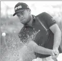  ??  ?? Tyrrell Hatton hits out of a bunker on the second hole.