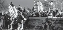  ?? JASON ANDREW/THE NEW YORK TIMES ?? Supporters of then-President Donald Trump face police Jan. 6 outside the U.S. Capitol. Five people, including a police officer, died in a riot that day.