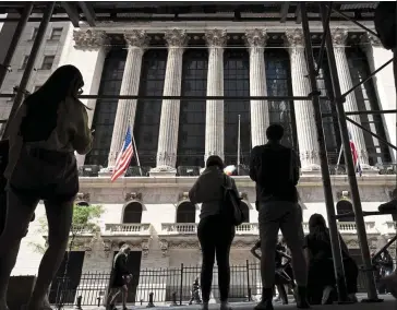  ?? — AP ?? Tricky times: People walk past the New York Stock Exchange. Thin bond-market liquidity will add pressure to the Fed’s efforts to reduce its balance sheet, analysts suggest.