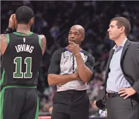  ?? TIM FULLER/USA TODAY ?? NBA referees such as Tom Washington answer written questions, review video and talk with replay staffers before issuing a pool report.