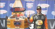  ?? Sarah Crabill / Getty Images ?? Martin Truex Jr. poses with the trophy after winning the Monster Energy NASCAR Cup Series Auto Club 400 at Auto Club Speedway in Fontana, California.