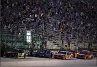  ?? (AP/Mark Humphrey) ?? Cars run during the NASCAR Cup Series All-Star Race on Wednesday at Bristol, Tenn. The track was allowed to sell up to 30,000 tickets for the race and Texas Motor Speedway has been allowed to admit up to 67,500 spectators for Sunday’s race. Iowa Speedway, which is owned by NASCAR, will allow up to 60,000 fans for this weekend’s IndyCar race.