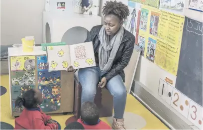  ?? Pictures: AFP ?? GREAT HOPE. Teacher Lebogang Gobodo reads a book to her pupils in her classroom at Ubuntu Pathways complex in Gqeberha, Eastern Cape, which is in the middle of a township of nearly one million people.