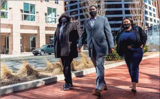  ?? Kerem Yucel / AFP / TNS ?? George Floyd's brother Rodney Floyd, left, Brandon Williams, nephew, center, and another Floyd family member arrive at the Hennepin County Government Center on Wednesday in Minneapoli­s.