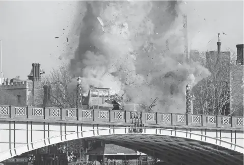  ?? STEVE PARSONS, PA WIRE ?? Filmmakers exploded a double-decker bus on Lambeth Bridge near the Houses of Parliament in London in February 2016.