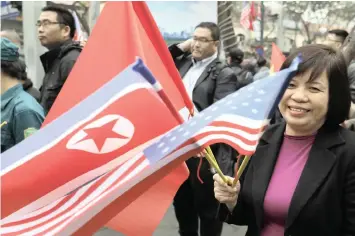  ?? AP African News Agency (ANA) ?? A WOMAN waves flags yesterday outside the Melia Hotel where North Korea leader Kim Jong-un will stay in Hanoi. The second US-North Korea summit takes place in Vietnam today and tomorrow. | VINCENT YU