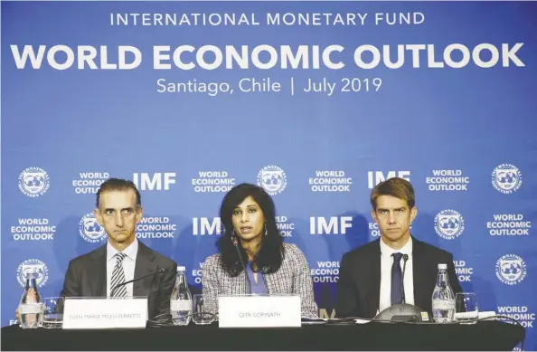  ??  ?? IMF chief economist Gita Gopinath, centre, said that a “major downside risk to the outlook remains an escalation of trade and technology tensions that can significan­tly disrupt global supply chains,” during a news conference in Santiago, Chile on Tuesday. Rodrigo GARRIDO/REUTERS