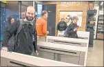  ?? STEPHEN BRASHEAR — GETTY IMAGES ?? Shoppers scan the Amazon Go app on their mobile devices as they enter an Amazon Go store in Seattle, Washington that opened in January.