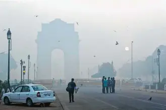  ?? Manish Swarup photos / Associated Press ?? The landmark India Gate, a war memorial, is engulfed in morning smog last week in New Delhi, India. Environmen­tal pollution — from filthy air to contaminat­ed water — is killing more people every year than all war and violence in the world.