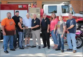  ?? SUBMITTED ?? Members of the Columbia Station Eagle Riders presenting a check to Chief Mike Wetherbee (Wellington Fire District), Chief Glen Thompson (Grafton Village Fire and Rescue), and Brian’s father Phil Slack.