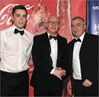  ??  ?? David O’Reilly presents the Team of the Year award to Ronan Phillips (right) and Andy McDonnell from Newtown Blues at the Drogheda Independen­t Coca-Cola Sport Star Awards in the Westcourt Hotel.
