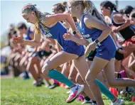  ?? JIM WEBER/NEW MEXICAN FILE PHOTO ?? St. Michael’s Raylee Hunt, left, gets a jump on the competitio­n at the start of the 3A girls race during the 2021 State Cross-Country Championsh­ip in November at Albuquerqu­e Academy.