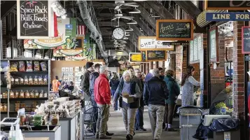  ?? STAFF FILE ?? Vendors at 2nd Street Market in Dayton offer a wide range of holiday food options.