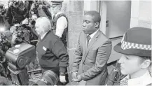 ?? Sang Tan / Associated Press file ?? Kweku Adoboli is led by police out of a London court in 2011. The trader served about half of a seven-year sentence.