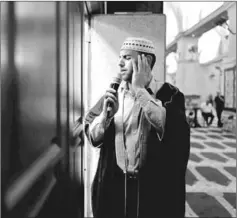  ??  ?? Firas Kazaz, a Palestinia­n muezzin, dressed in traditiona­l clothing, calls Muslims to prayer, inside al-Aqsa Mosque. — Reuters photo