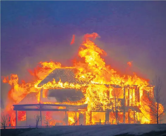  ?? Photo / Getty Images ?? One of many homes devastated by the wildfires sweeping through Colorado burns after the flames, fanned by winds of up to 170km/h, hit Louisville yesterday.