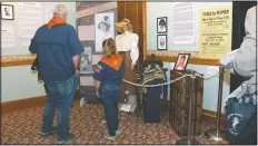  ?? (File photo/AP/Bob Christie) ?? Visitors to the Arizona Capitol Museum look at a display honoring the state’s early suffrage movement on March 11 in Phoenix. The display includes a mannequin dressed in period consume depicting Frances Willard Munds, who led a successful 1912 ballot initiative that gave women the right to vote.