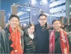  ??  ?? Yusry and Adam and MDF representa­tives pose in front of the iconic gate at Anfield Stadium after being treated to a LIVE Premier League match after the trials.