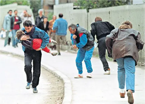  ??  ?? ‘Sniper alley’, the main road into Sarajevo, Bosnia’s capital city, during the Yugoslav wars. Pedestrian­s, below, walk near the Sarajevo City Centre business and shopping complex