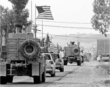  ?? SAFIN HAMED/GETTY-AFP ?? A convoy of US military vehicles arrives Monday near the Iraqi Kurdish town of Bardarash after leaving northern Syria.