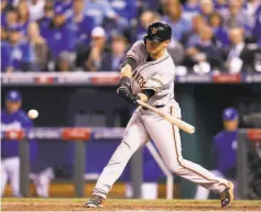  ?? Michael Macor / The Chronicle 2014 ?? Joe Panik hits an RBI triple in the seventh inning of Game 1 of the 2014 World Series, which the Giants won in seven games.