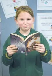  ??  ?? Garfield Primary School student Rylee Craven enjoys being able to pick her own books for the school’s reading Cafe.