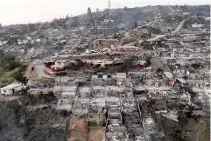  ?? AFP PHOTO ?? CHILLING SCENE
An aerial view of a devastated community in the aftermath of a wildfire in Villa Independen­cia, Valparaiso region, central Chile on Sunday, Feb. 4, 2024.
