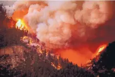 ?? JERRY MCBRIDE/DURANGO HERALD ?? The 416 Fire burns along U.S. 550 on the southeaste­rn side of the fire north of Durango, Colo., on Wednesday.