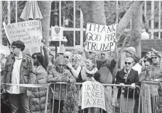  ?? SETH HARRISON, THE (WESTCHESTE­R COUNTY, N.Y.) JOURNAL NEWS ?? Dueling signs at a demonstrat­ion in New York on April 15.