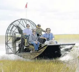  ?? MICHAEL LAUGHLIN/SUN SENTINEL ?? Republican gubernator­ial nominee Ron DeSantis, top left, tours the Everglades south of Alligator Alley on Wednesday. The airboat was piloted by Broward’s Ron Bergeron, top right.