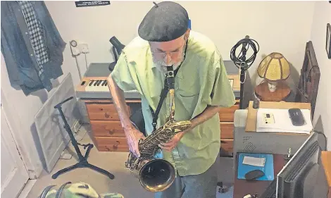  ??  ?? Jim Morrice plays saxophone while recording his New Orleans-style album.