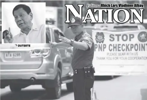  ?? REUTERS ?? DUTERTEA police officer signals to motorists at a Philippine National Police (PNP) checkpoint in Metro Manila.