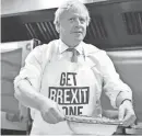 ?? GETTY IMAGES ?? Britain’s Prime Minister Boris Johnson prepares a pie at the Red Olive kitchen in Derby, England, on the final day of campaignin­g before a general election on Dec. 12.