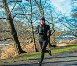  ?? — AFP photos ?? A woman runs during her lunch break at Djurgarden park in Stockholm.