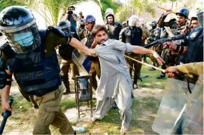  ?? K.M. CHAUDARY/ASSOCIATED PRESS ?? During protests Wednesday in Lahore, police detained a supporter of Imran Khan, a former Pakistani prime minister whose arrest has sparked unrest.