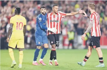  ?? — AFP photo ?? Brentford’s Spanish goalkeeper David Raya (second left) celebrates with Brentford’s Danish defender Mathias Jorgensen (second right) at the final whistle during the English Premier League football match between Brentford and Liverpool at Brentford Community Stadium in London.