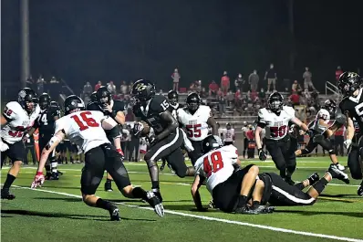  ?? Photo by Kevin Sutton ?? ■ Pleasant Grove running back Jaylen Boardley makes his way upfield as he is pursued by the Argyle defense. The Eagles defeated the Hawks, 52-41, on Friday at Hawk Stadium in Texarkana.