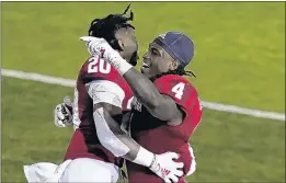  ?? DARRON CUMMINGS/AP ?? Indiana's Joseph Daniels Jr. (20) and Cam Jones celebrate after Indiana defeated Penn State in overtime. It was Indiana's first win over a Top-10 team since 1987.