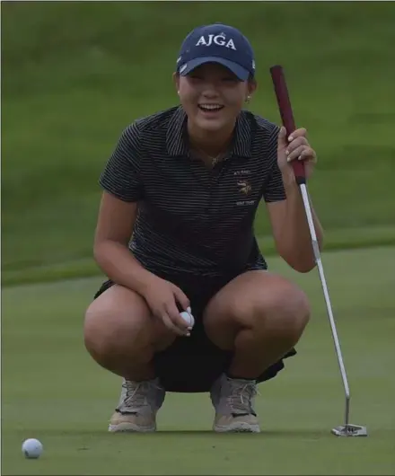  ?? PETE BANNAN — DIGITAL FIRST MEDIA ?? Victoria Kim is all smiles as she waits to place her ball on the 18th hole at the District 1 Golf Championsh­ip at Turtle Creek Tuesday.