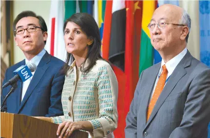 ?? AP-Yonhap ?? U.S. Ambassador to the United Nations Nikki Haley, center, speaks to reporters as Korean Ambassador Cho Tae-yul, left, and Japanese Ambassador Koro Bessho look on before a Security Council meeting on the situation in North Korea at the United Nations...