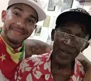  ??  ?? Emotional: Lewis Hamilton with his grandfathe­r Davidson, who died last week