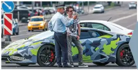  ?? ?? RUSSIAN PLAYBOY HACKER
Lamborghin­i lover: Maksim Yakubets, right, has bragged about attacks by his Evil Corp outfit