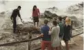  ?? TOURISM NEW ZEALAND ?? Staff lift steambox lunches out of a pit.