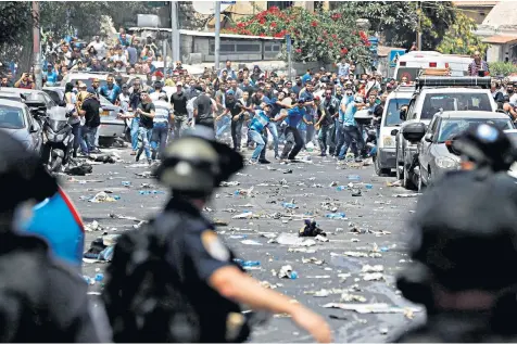  ??  ?? Palestinia­ns hurl stones at Israeli security forces outside Jerusalem’s Old City. The latest violence comes after Israel set up metal detectors outside the al-aqsa mosque