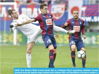  ?? — AFP ?? EIBAR: Real Madrid’s Welsh forward Gareth Bale (L) challenges Eibar’s Argentinia­n midfielder Gonzalo Escalante during the Spanish league football match between Eibar and Real Madrid at the Ipurua stadium in Eibar yesterday.