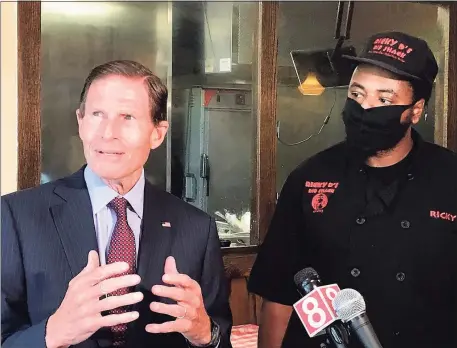  ?? Luther Turmelle / Hearst Connecticu­t Media ?? U.S. Sen. Richard Blumenthal, D-Conn., and Ricky Evans, the owner of Ricky D’s Rib Shack in New Haven, talk with reporters Wednesday about the federal Payroll Protection Program. Blumenthal visited Evans’ restaurant in an effort to urge that the $130 billion that remains in the program be focused on small and minority owned businesses.