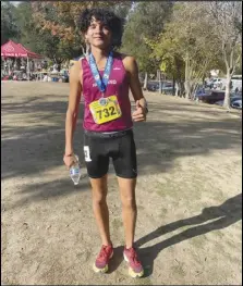  ?? Courtesy photo ?? Highland senior Matthew Donis poses with his championsh­ip medal after winning the CIF State Boys Division 1 Cross Country title on Saturday at Woodward Park in Fresno.